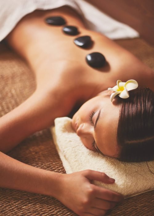 Portrait of young female lying in spa salon during beauty procedure